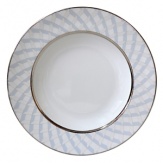 Carefully rendered in a style reminiscent of neoclassic trompe l'oeil-a French term for artwork that depicts optical illusions-a captivating geometric rosette motif traverses this elegant porcelain soup bowl from Bernardaud. Delicate shades of ice blue, mother-of-pearl and gray are enhanced by a fine platinum trim.