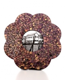 A myriad of glass pieces collect in a flower design to create this shimmering and brilliant picture frame from Purva. A myriad of glass pieces collect in a flower design to create this shimmering and brilliant picture frame from Purva.