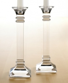 A modern take on a classic design, these crystal candlesticks feature sleek lines and sharp, precise edges that converge on a substantial base. In clear lead crystal. A modern take on a classic design, these crystal candlesticks feature sleek lines and sharp, precise edges that converge on a substantial base. In clear lead crystal.