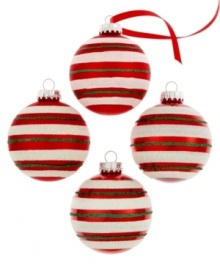 Stripes of green and white glitter on holiday-red ball ornaments tailor the tree in timeless holiday style. Stripes of green and white glitter on holiday-red ball ornaments tailor the tree in timeless holiday style.