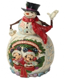 Celebrate the season with your favorite friends. Mickey and Minnie Mouse step in for Santa in this brightly colored scene, which combines bursts of Christmas color, winter wonderland designs and a very welcoming snowman. Celebrate the season with your favorite friends. Mickey and Minnie Mouse step in for Santa in this brightly colored scene, which combines bursts of Christmas color, winter wonderland designs and a very welcoming snowman.