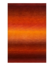 Imparting warm visions of brilliant sunrises on the horizon, this deeply textured rug features intense tones of red and orange that recall a perfect morning sky. Hand-tufted and color blended with the greatest of care, this wool rug comes alive with texture and color. Imparting warm visions of brilliant sunrises on the horizon, this deeply textured rug features intense tones of red and orange that recall a perfect morning sky. Hand-tufted and color blended with the greatest of care, this wool rug comes alive with texture and color.