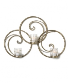 Equal parts wall art and lighting solution, the Symphony Swirl Ring sconce by Mikasa illuminates a room with a festive twist. Featuring whimsical swirls of goldtone metal and glass candle holders wrapped in shimmering ribbons. Equal parts wall art and lighting solution, the Symphony Swirl Ring sconce by Mikasa illuminates a room with a festive twist. Featuring whimsical swirls of goldtone metal and glass candle holders wrapped in shimmering ribbons.