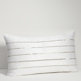 Embroidered and embellished decorative pillows complement the bedding ensemble.