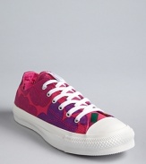 Classic Converse All Star sneakers get a kick from a vibrant heart and flower print.